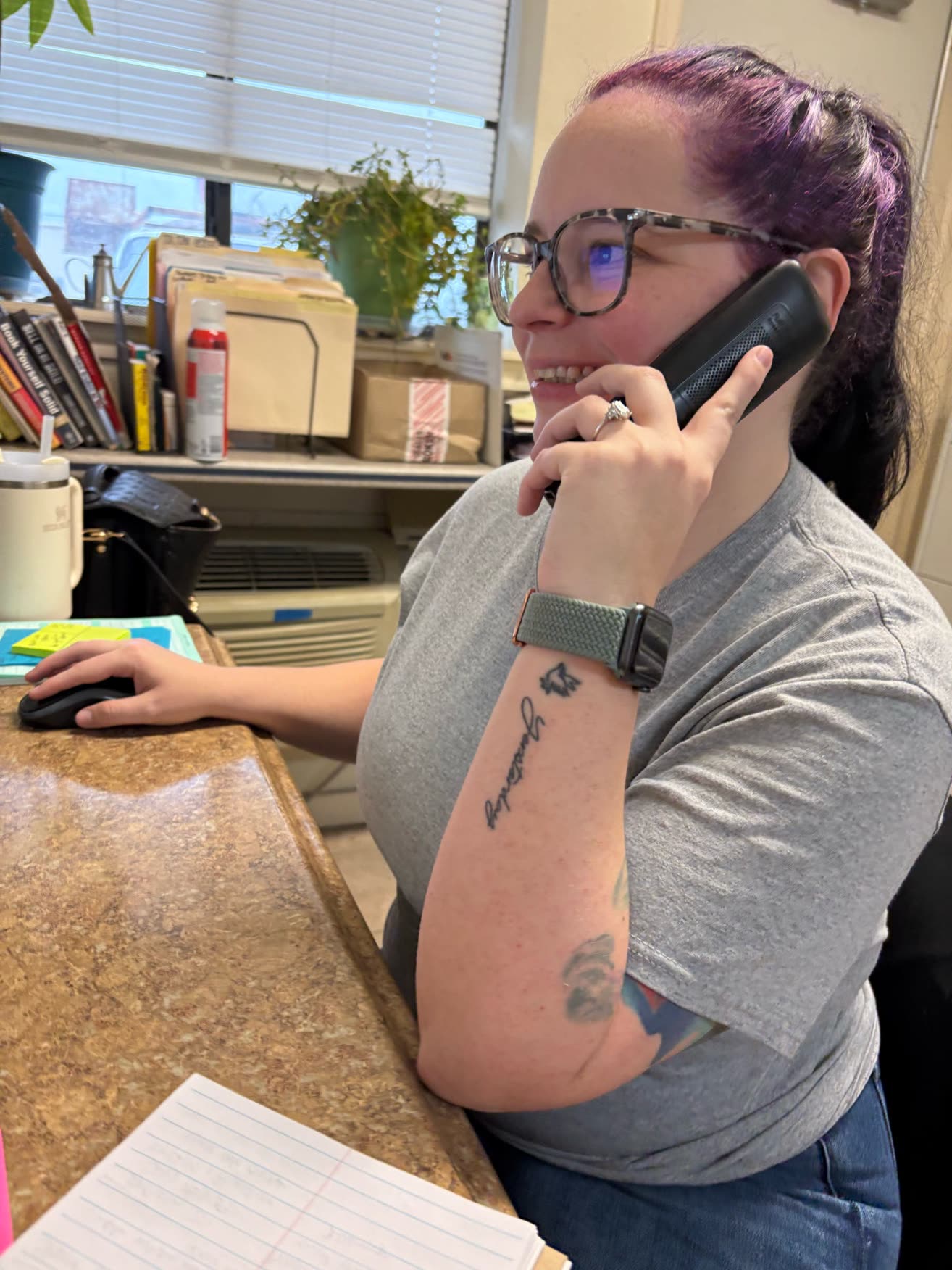 Ally at her desk, answering the office phone