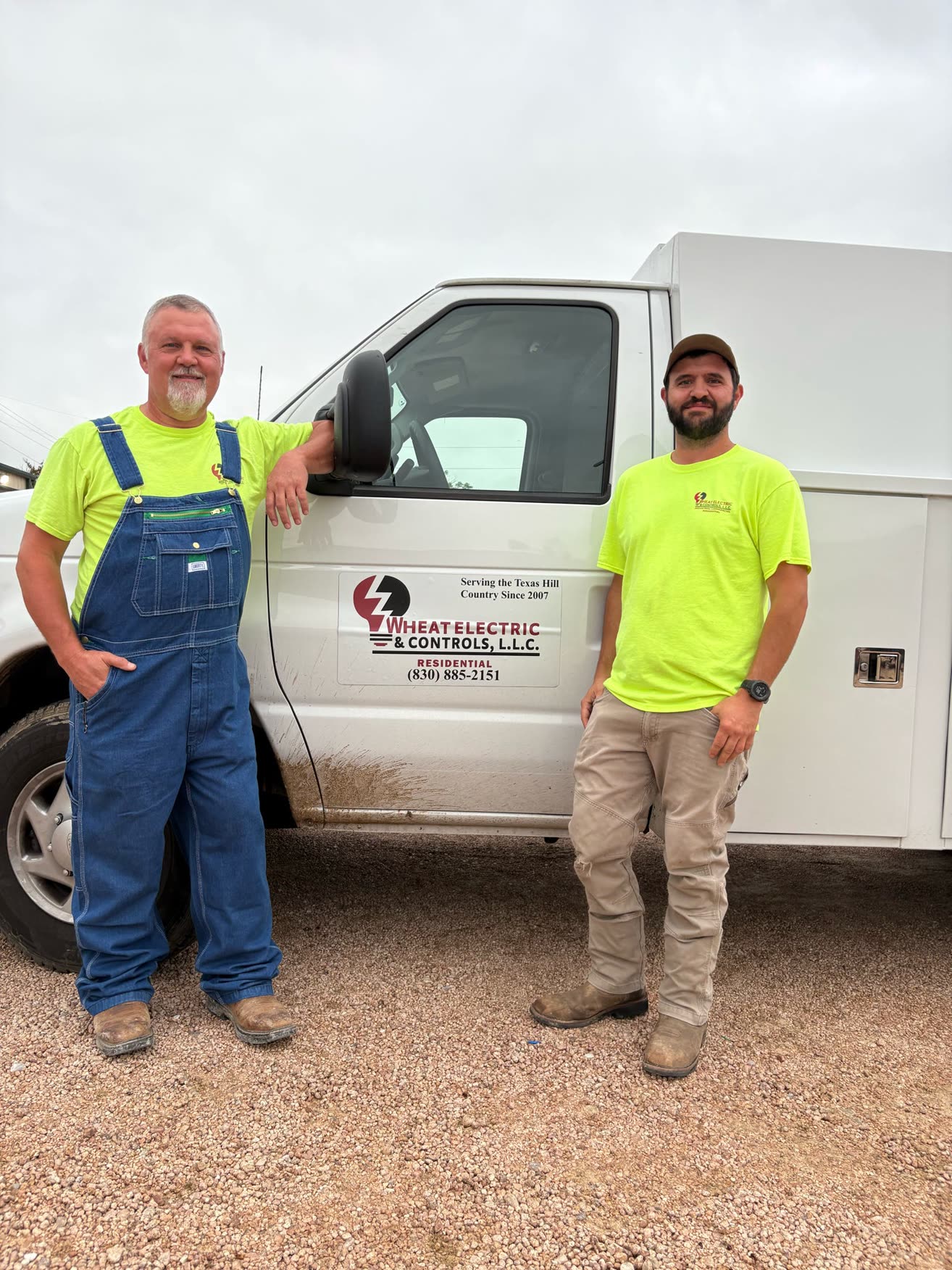 Ed Wheat and Jamie standing beside the white Wheat Electric residential van