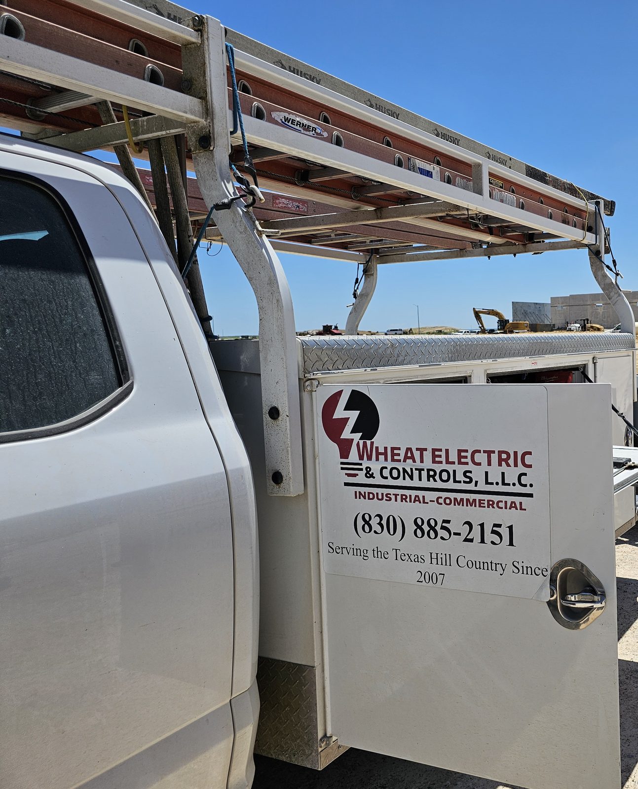 Wheat Electric truck door with the shop phone number and Hill Country since 2007