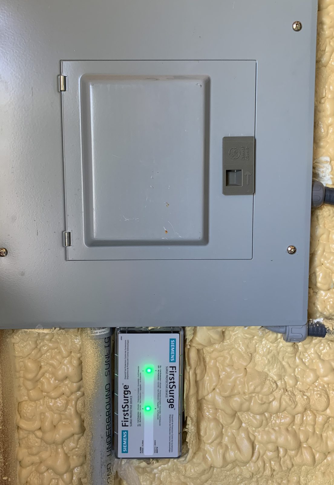 Siemens FirstSurge protector installed under a residential panel