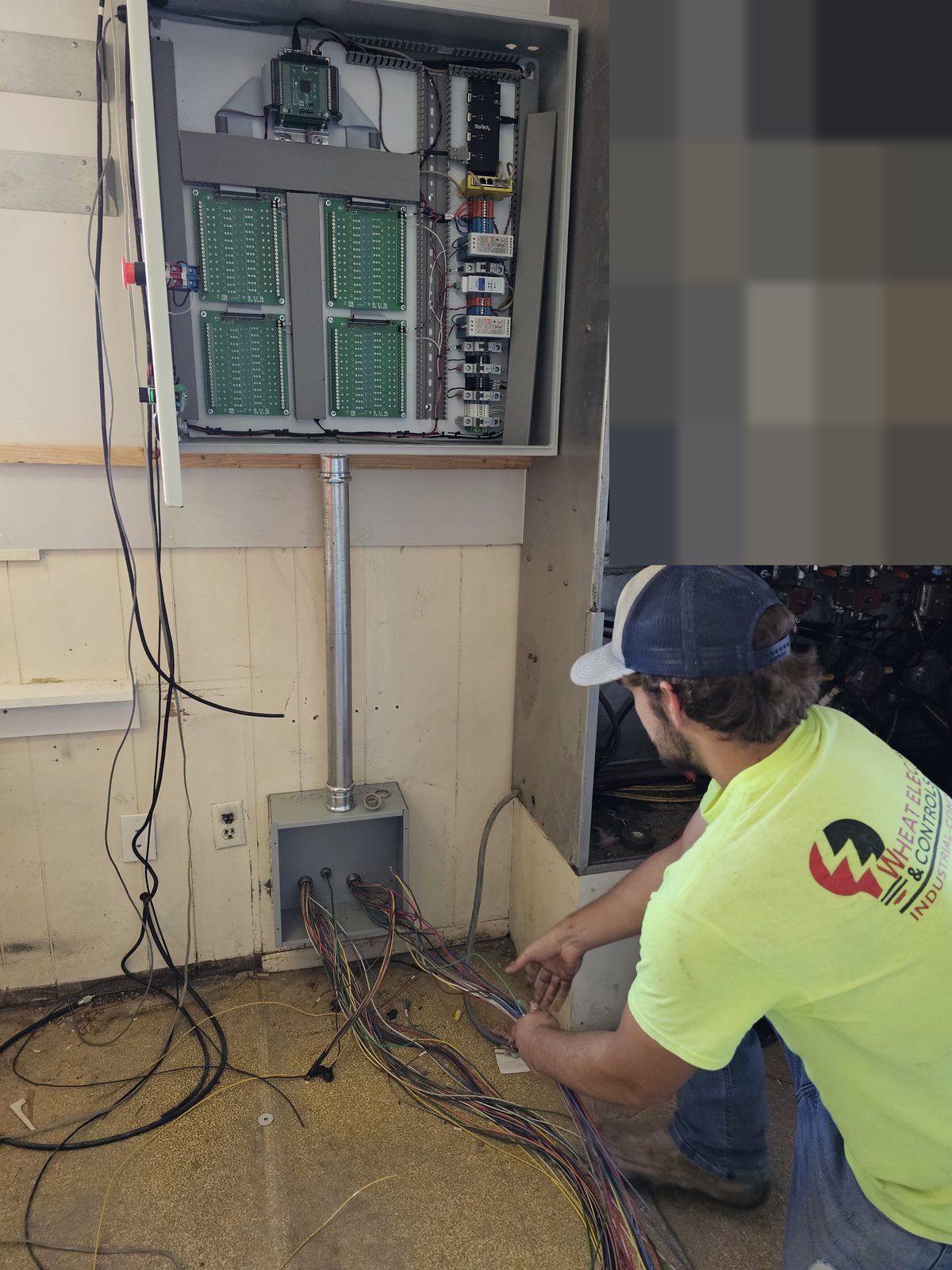 Crew member landing a bundle of control cable under an open panel