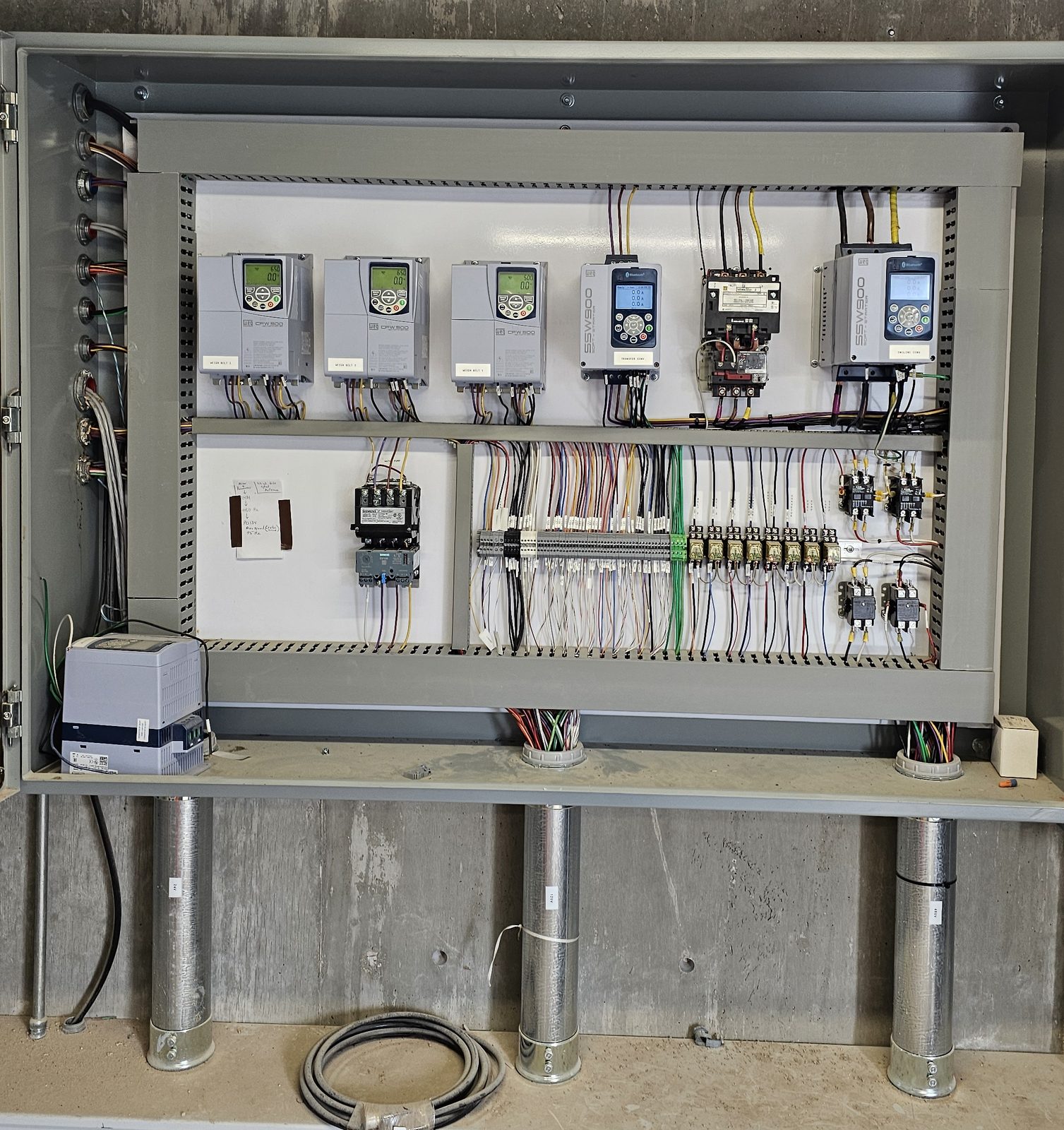 Open custom VFD cabinet with a row of drives and field wiring